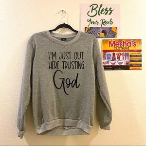 Grey Sweatshirt “I’m just out here trusting God”.